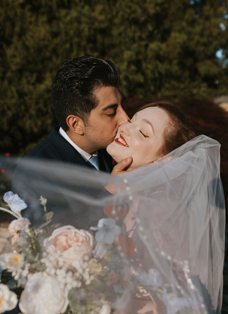Bride and groom sharing a kiss on their wedding day in NYC