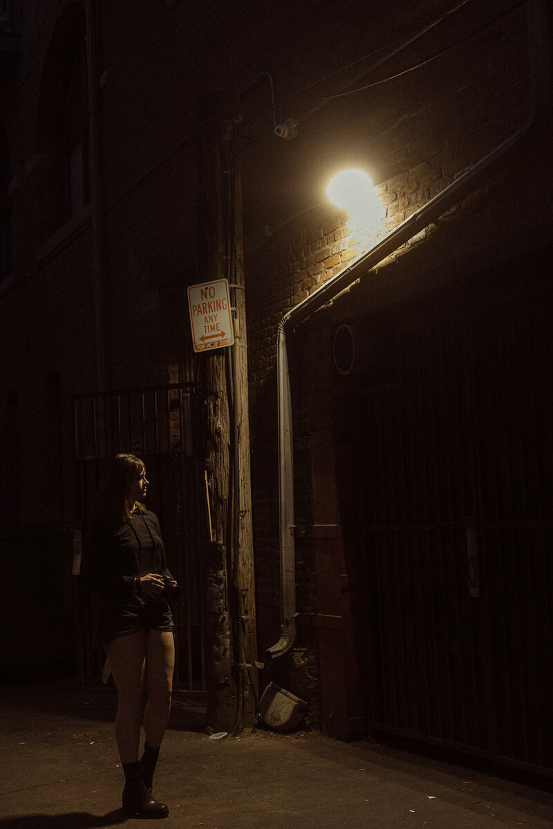 krista in alleyway with street light 