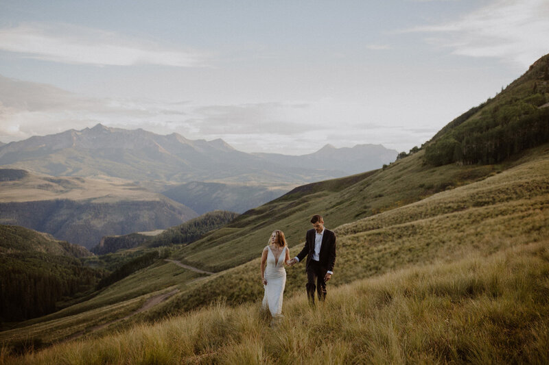 Couple walks on their elopement day in the Colorado mountains