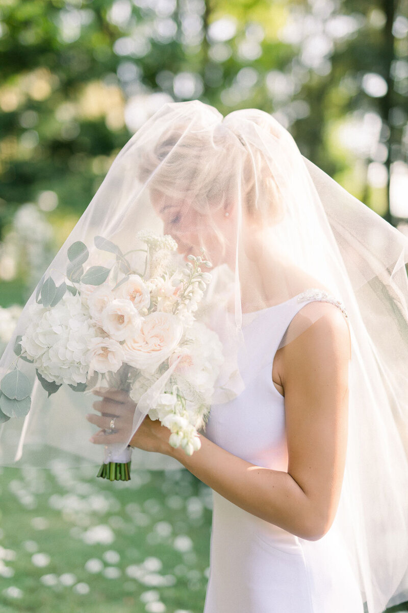 beautiful elegant bride with her muted colors bouquet