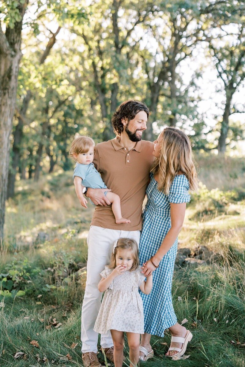 A family posing together for a portrait, taken by Emily Barbara, a family photographer in Milwaukee.