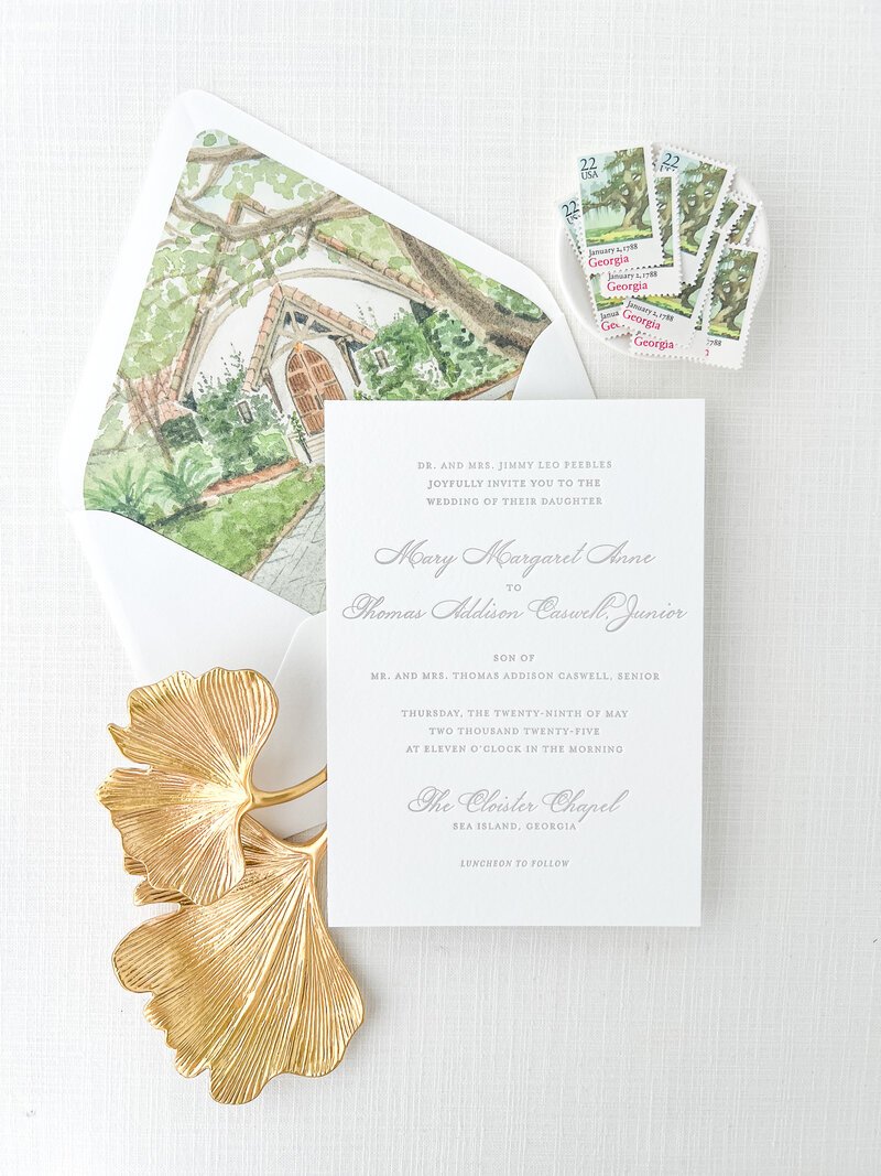 a wedding invitation suite held together by a belly band