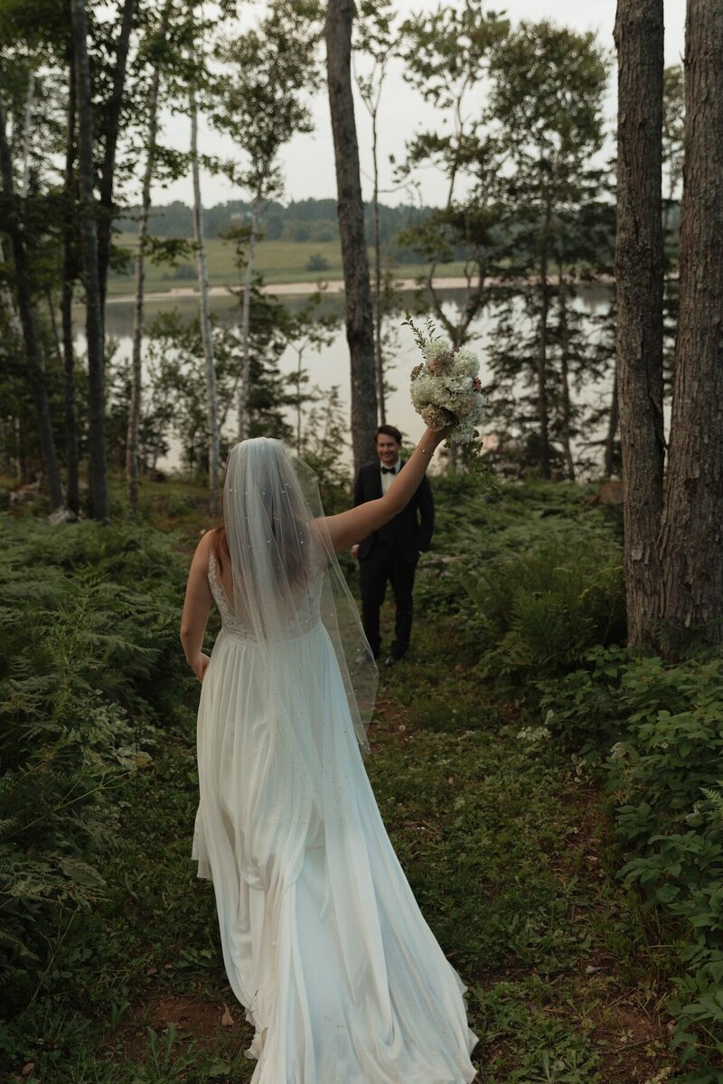 bride and groom in forest on wedding day in pei