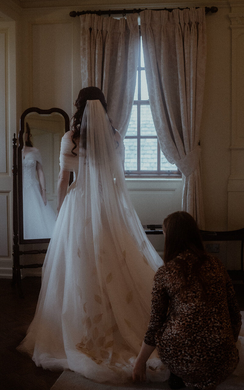 Capturing the bride's preparations with elegance and grace, this intimate moment showcases the excitement and beauty before the wedding ceremony begins