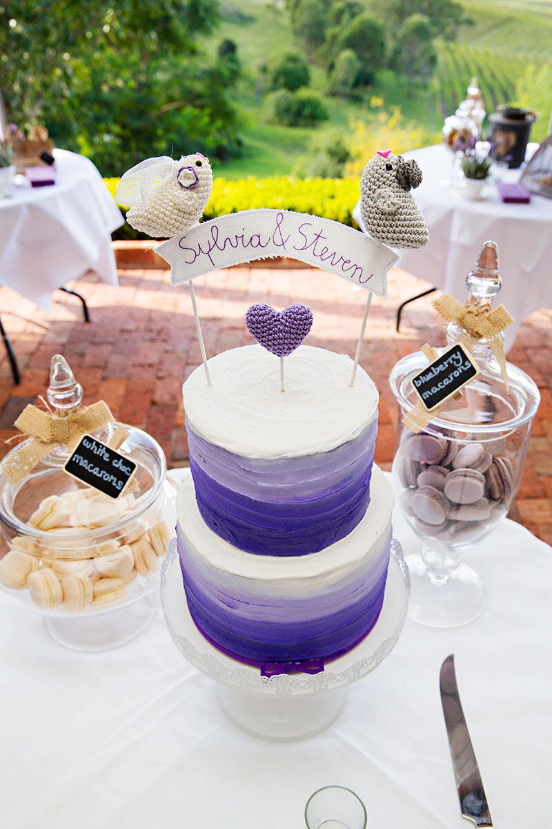 purple and white cake at reception