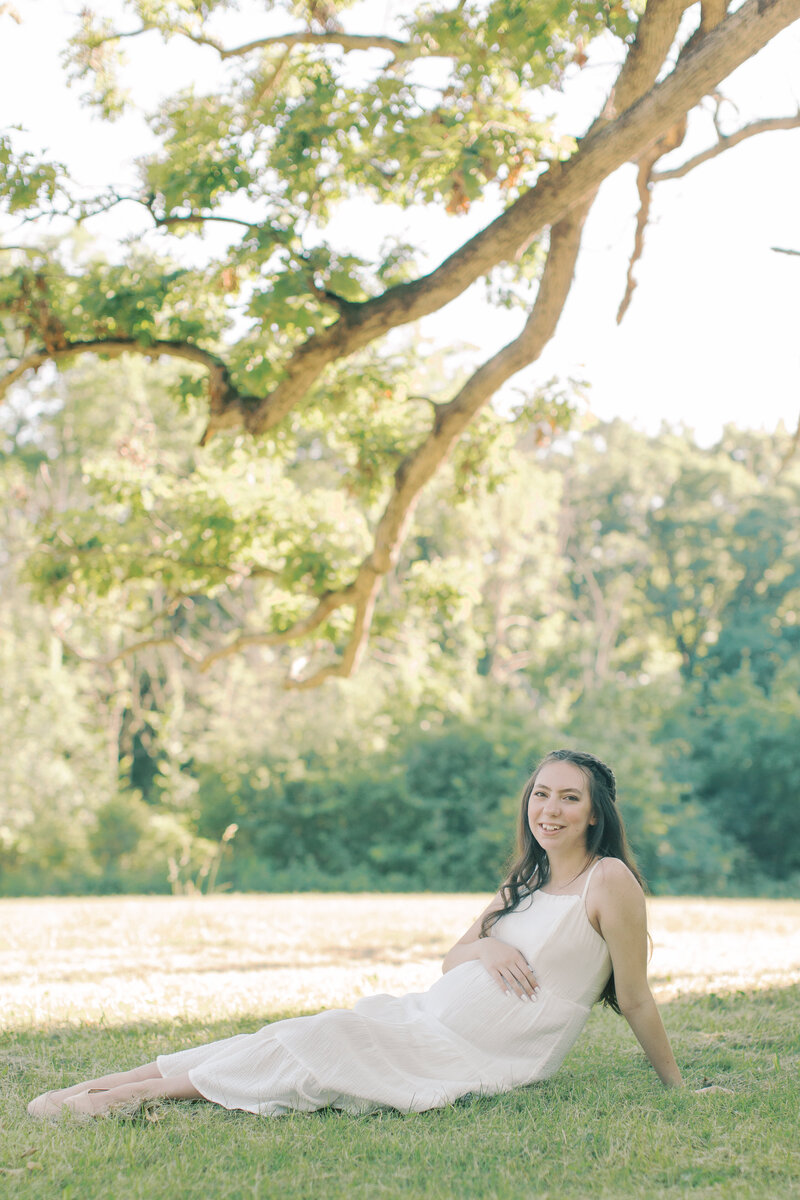 pregnant mother laying in a field