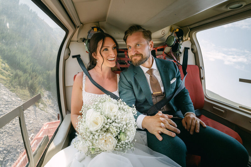 Capture the serene beauty of a bride looking out of a bedroom window after getting ready at the Banff Springs Hotel. A timeless and intimate moment of anticipation on her wedding day.