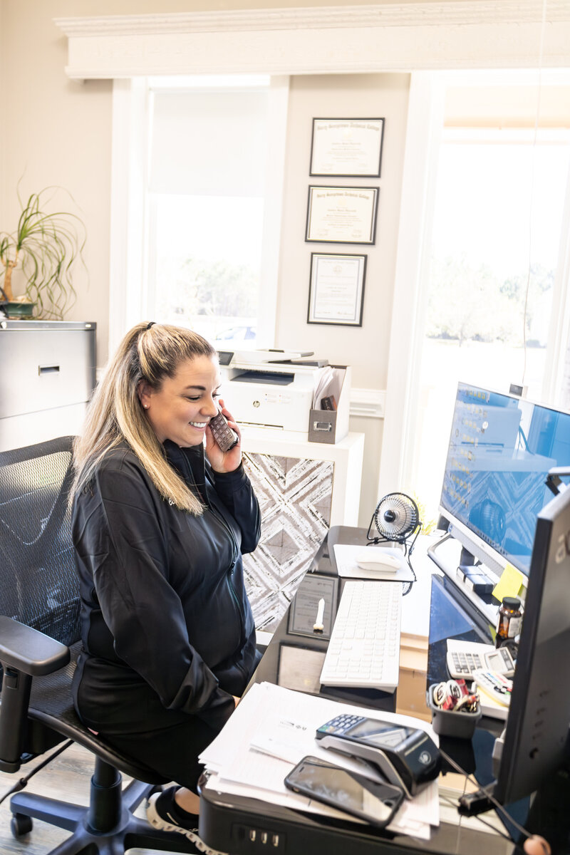 Candice, office manager talking on the phone