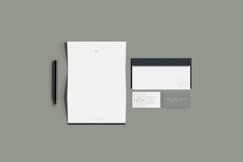 a mockup showing how branding can be used on a letterhead, envelope, and business cards