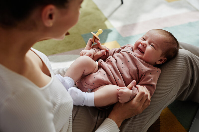 Baby smiling at mother