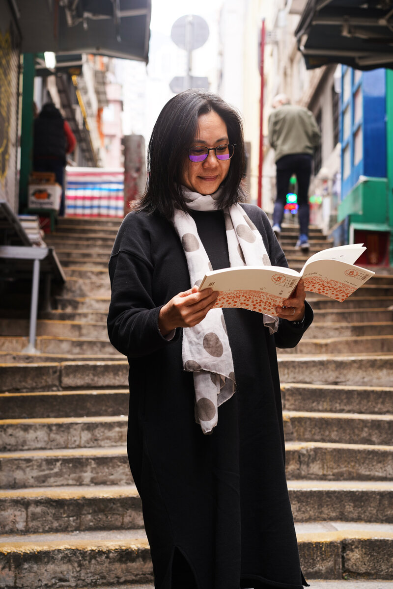 Author Maureen Tai reading book