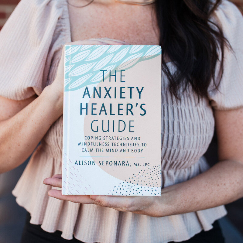 Alison Seponara holding the Anxiety Healers Guide book