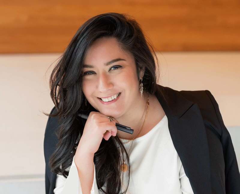 Mehroz Baig smiling in a professional setting, representing communications, employee engagement, and inclusion consulting.