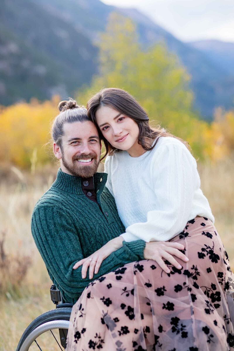 Photograph of couple looking at the camera taken by Hillary Shedd, a Colorado Engagement Photographer.