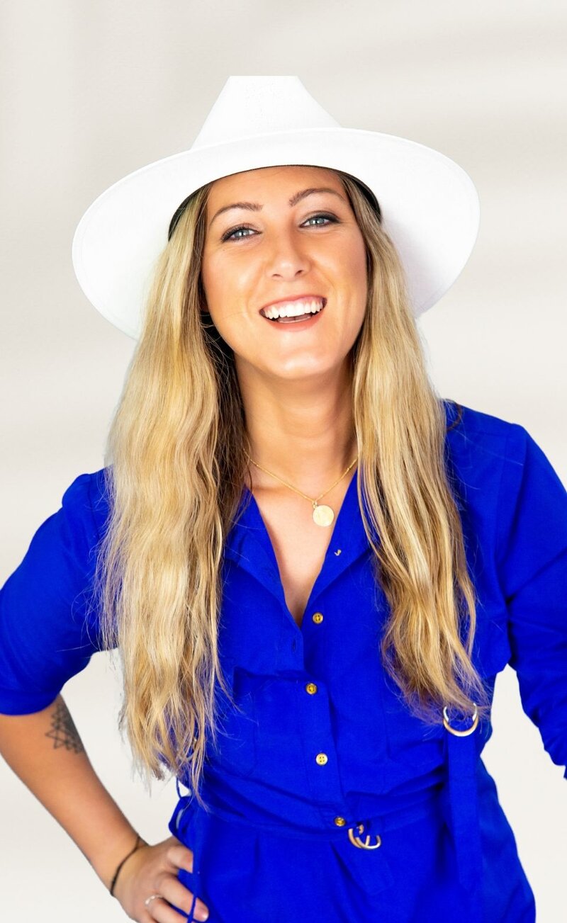 Caitlyn Dasilva the website and branding designer, Smiling With Hat