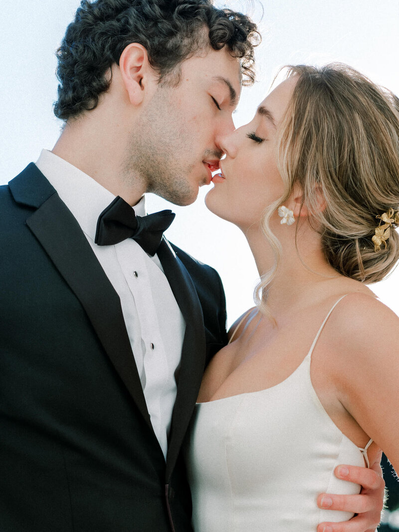 Bride and groom sharing a romantic moment and going in for a kiss