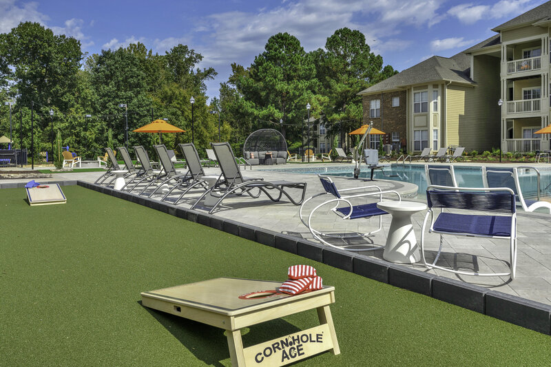 pool design with outdoor cornhole  boards