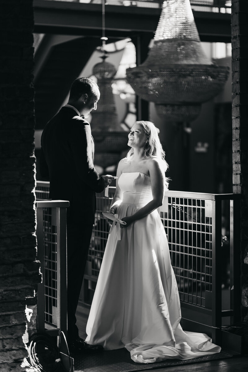 bride watches groom read his vows 