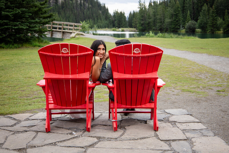A couple sitting in the iconic red Banff chairs