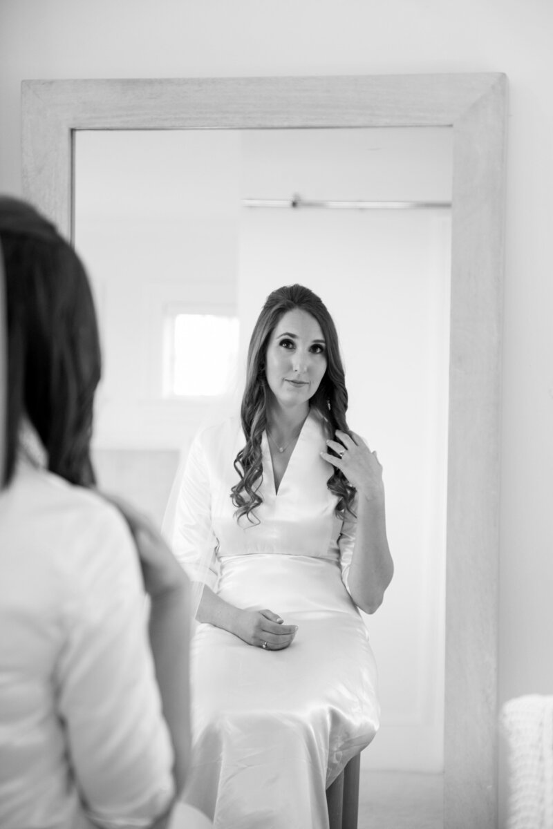 Bride looking in mirror before wedding | Maine Wedding Photography