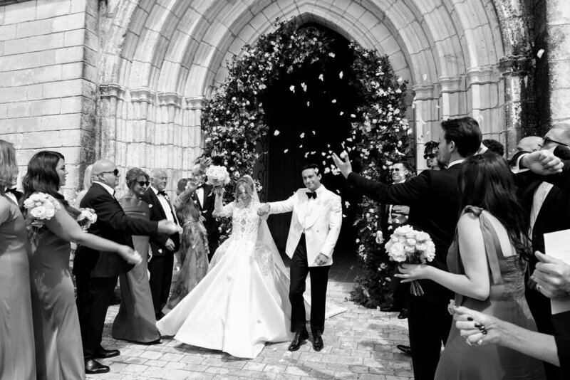 flower petal wedding send off from church in black and white
