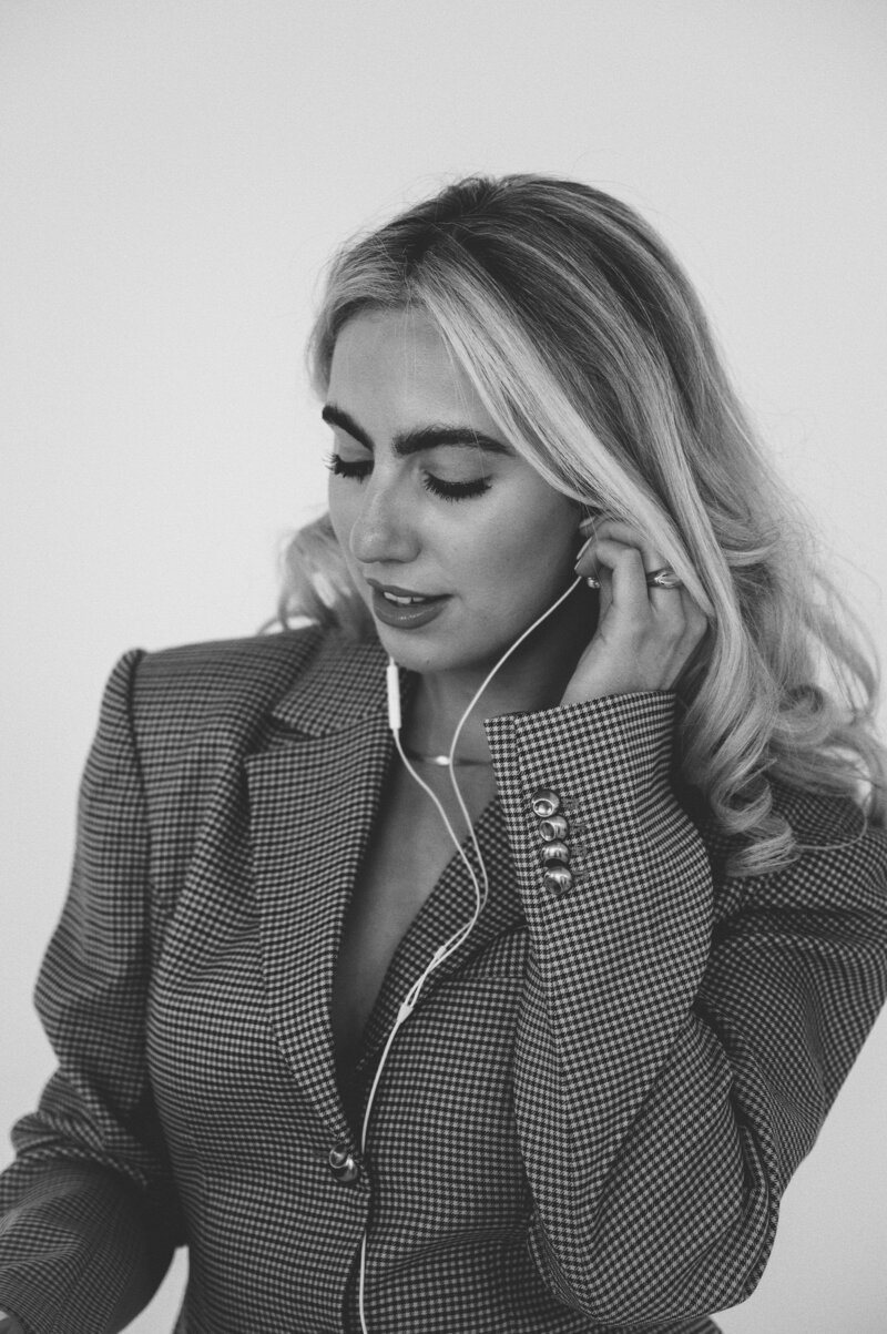 Black and white photo of Amelia Waters on the phone, representing the approachable, hands-on nature of Sunday Social Collective