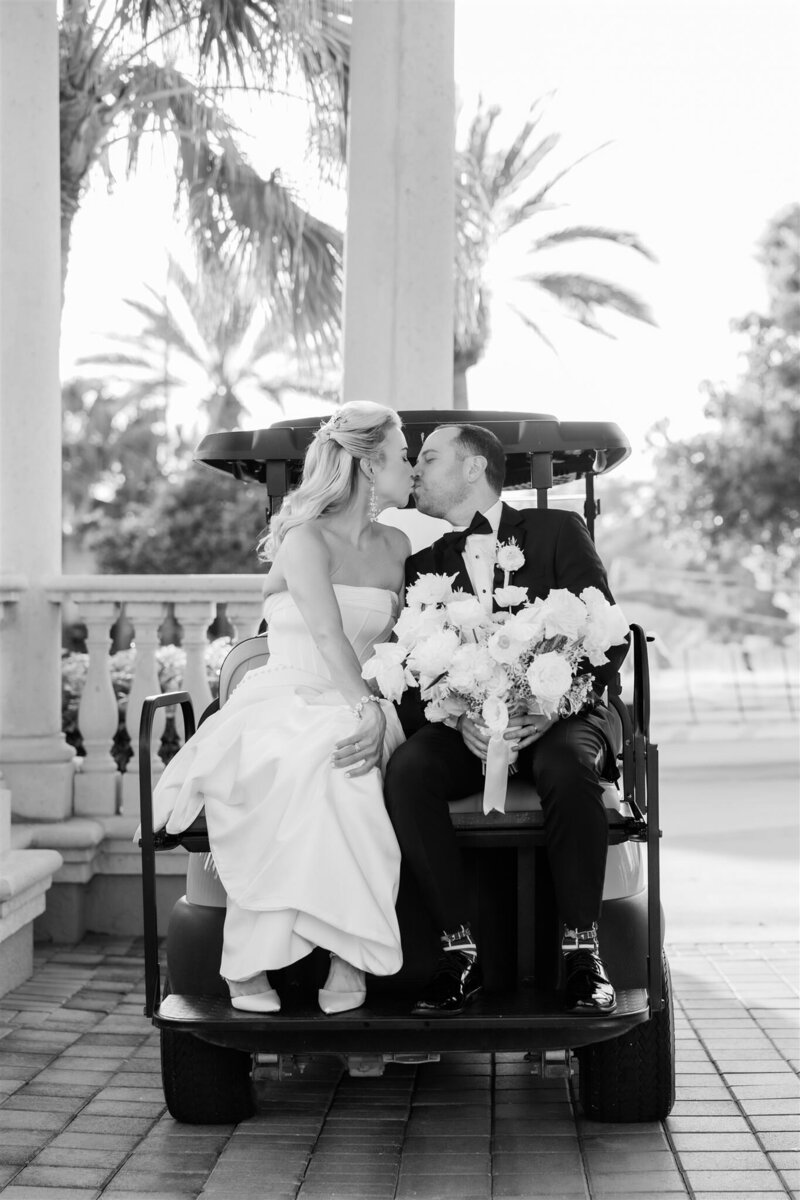 Bride and Groom Portrait in a golf cart at the Country Club of Orlando by Orlando wedding photographer