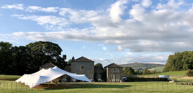 A long row of Pagoda marquees in a field