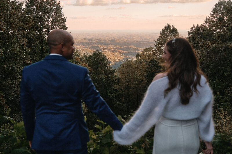 Eloping couple looks deeply at each other while the sun sets