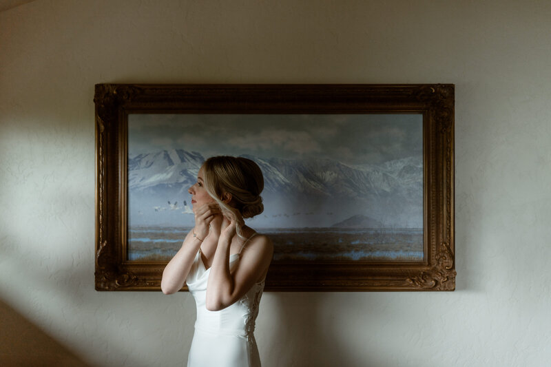 bride and groom standing on glacier