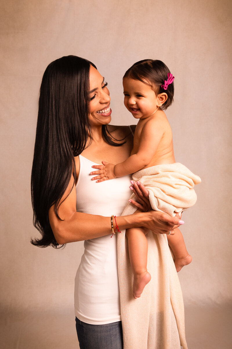 Mother with one year old daughter laughing captured by fort mill portrait photographer Alicia Insley Smith