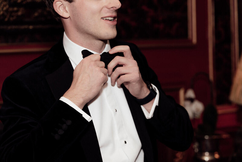 Destination wedding in Scotland groom puts on bow tie at Prestonfield House