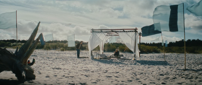 A stylish apartment interior featuring the lead character in a moment of reflection.