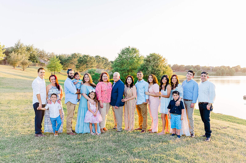 Extended family posing for photograph Cinco Ranch Lake House Park.