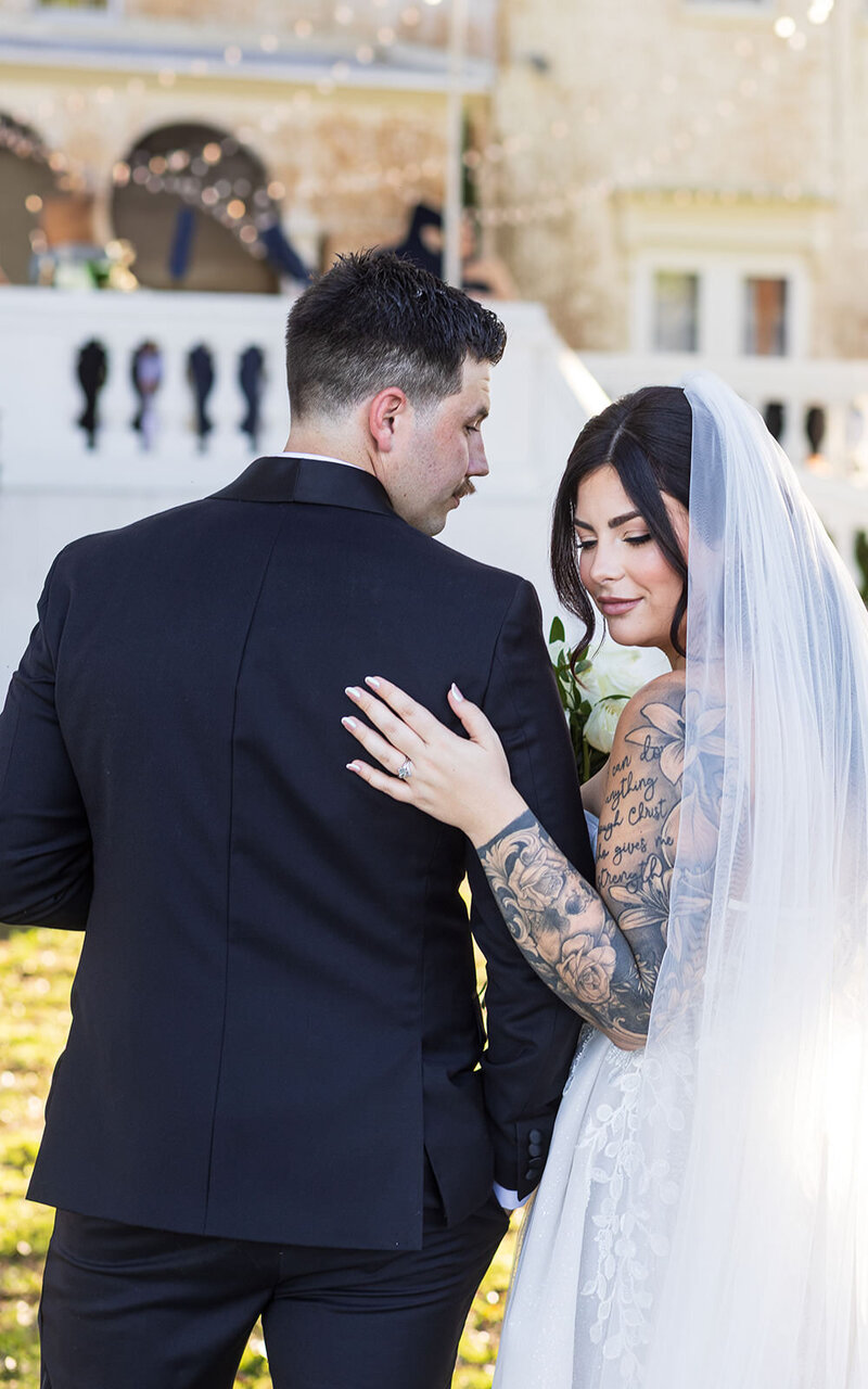 Jacksonville wedding photo of  a bride and groom in front of white balcony