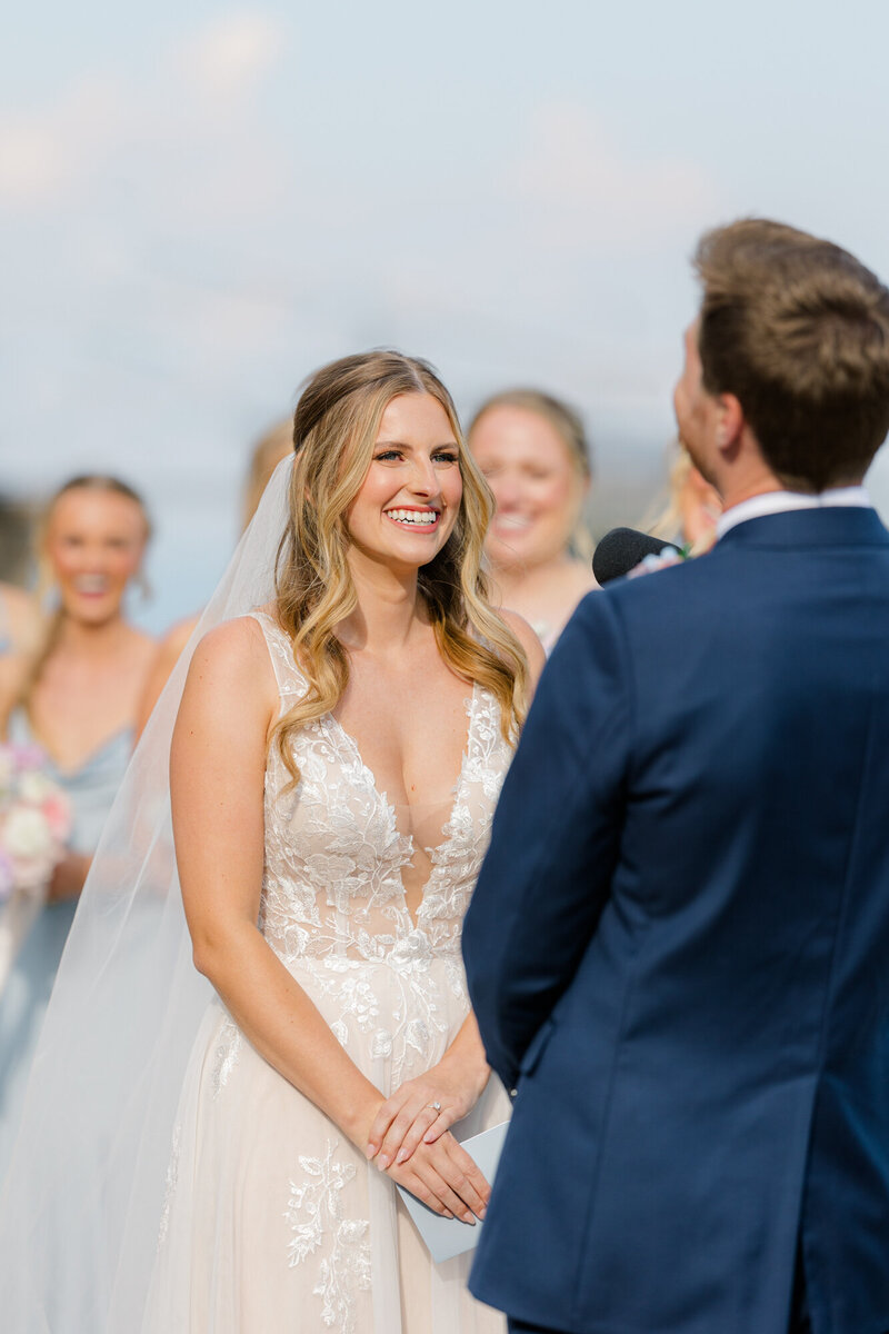 bride smiling at groom during ceremony