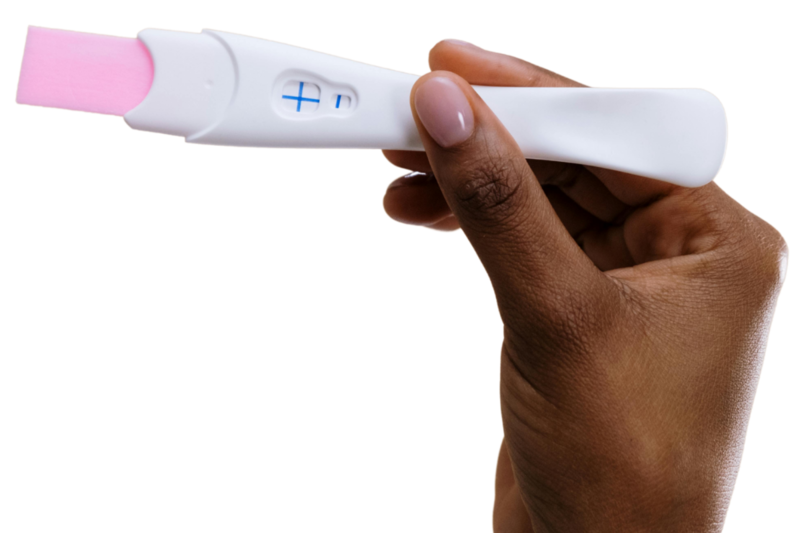 Close up of a woman's hand holding a pregnancy test after undergoing IVF