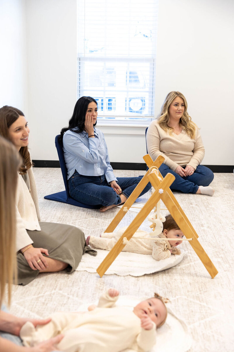 Women sitting in a circle on the floor with their babies