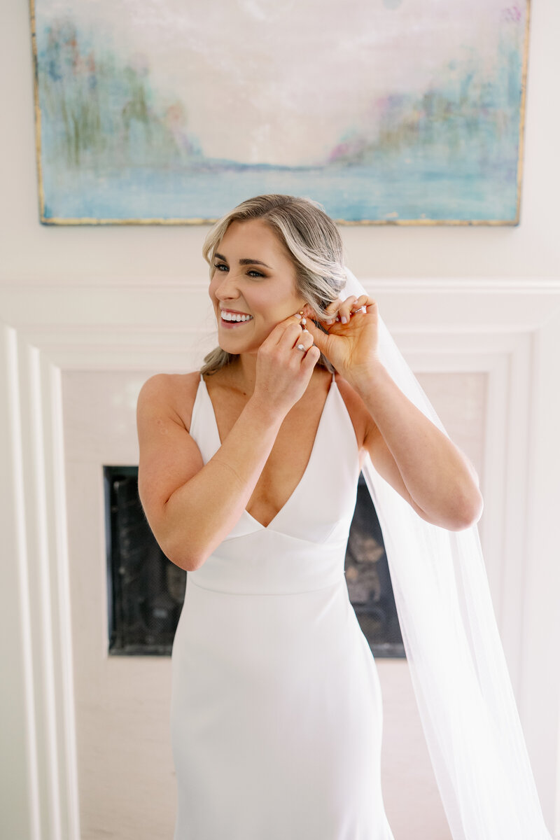 Bride getting ready and putting on jewelry at private residence in Vestavia Hills Alabama