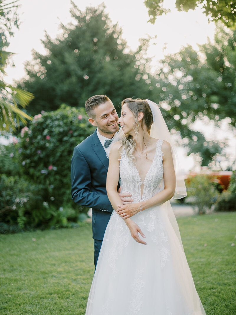 A-bride-and-groom-embracing-in-the-grass