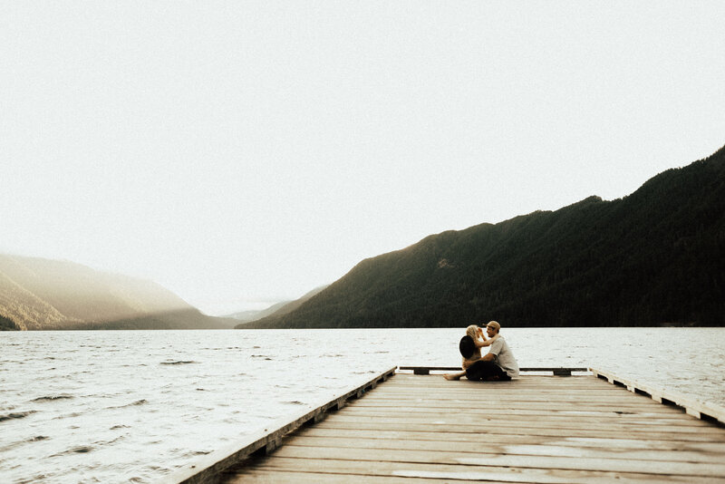 Couple sitting on a dock on Lake Cresent