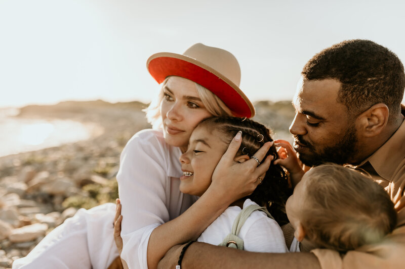 family embraces on beach