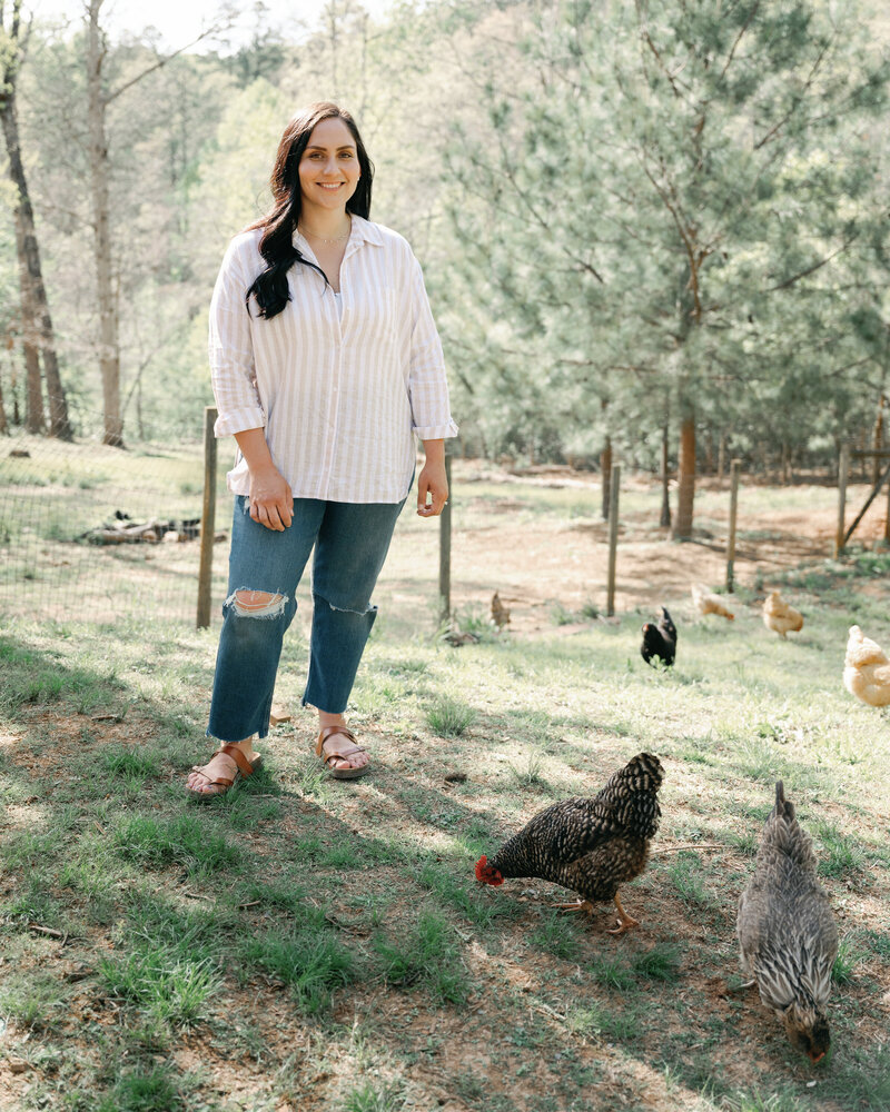 woman standing with her chickens on a north georgia homestead