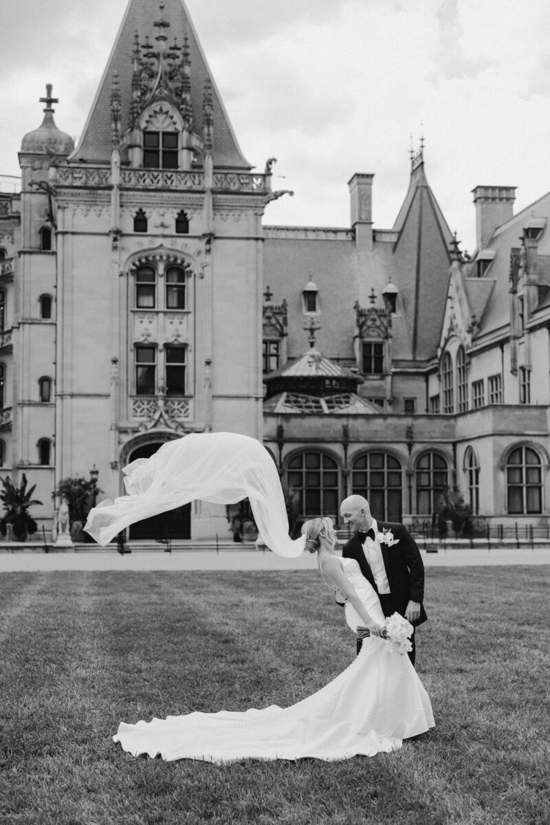 Bride in a Watters gown from Anthropologie strolling gracefully down the stairs of the Biltmore House.