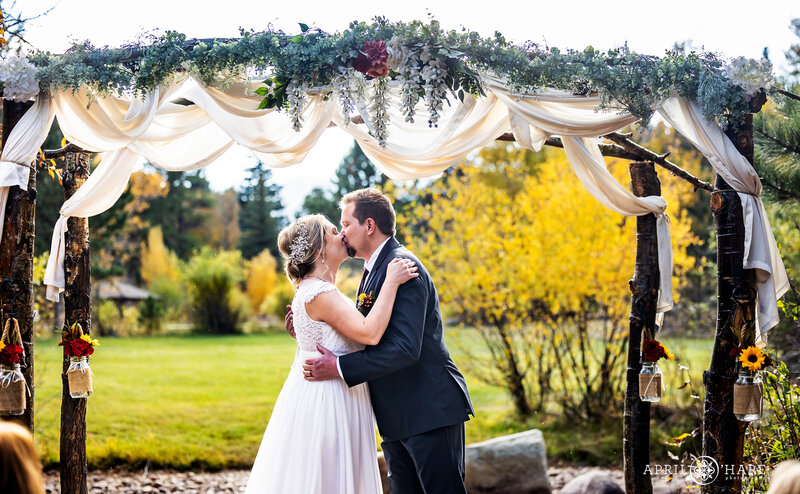 Wedding Photography of an Outdoor Ceremony by the River at Romantic Riversong Inn Estes Park