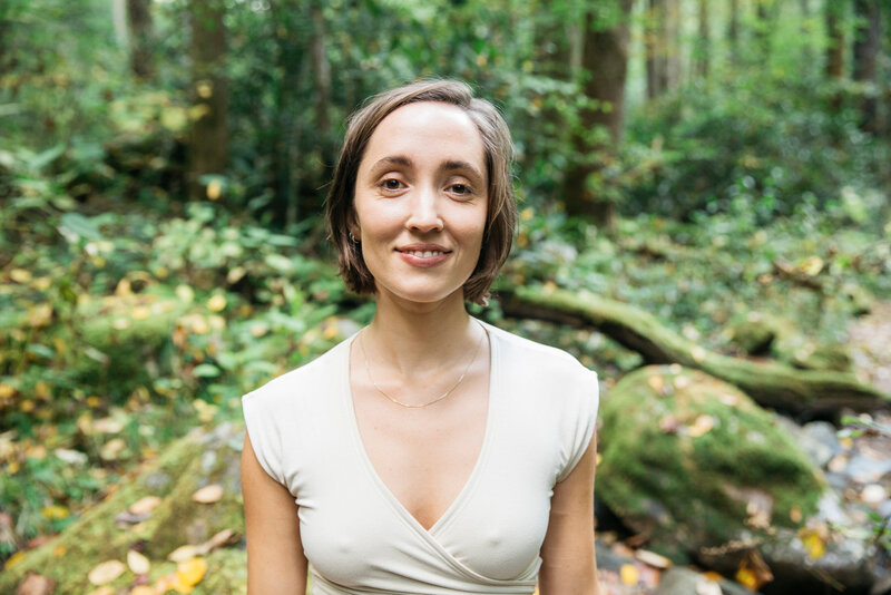 Woman on a green lush forest background