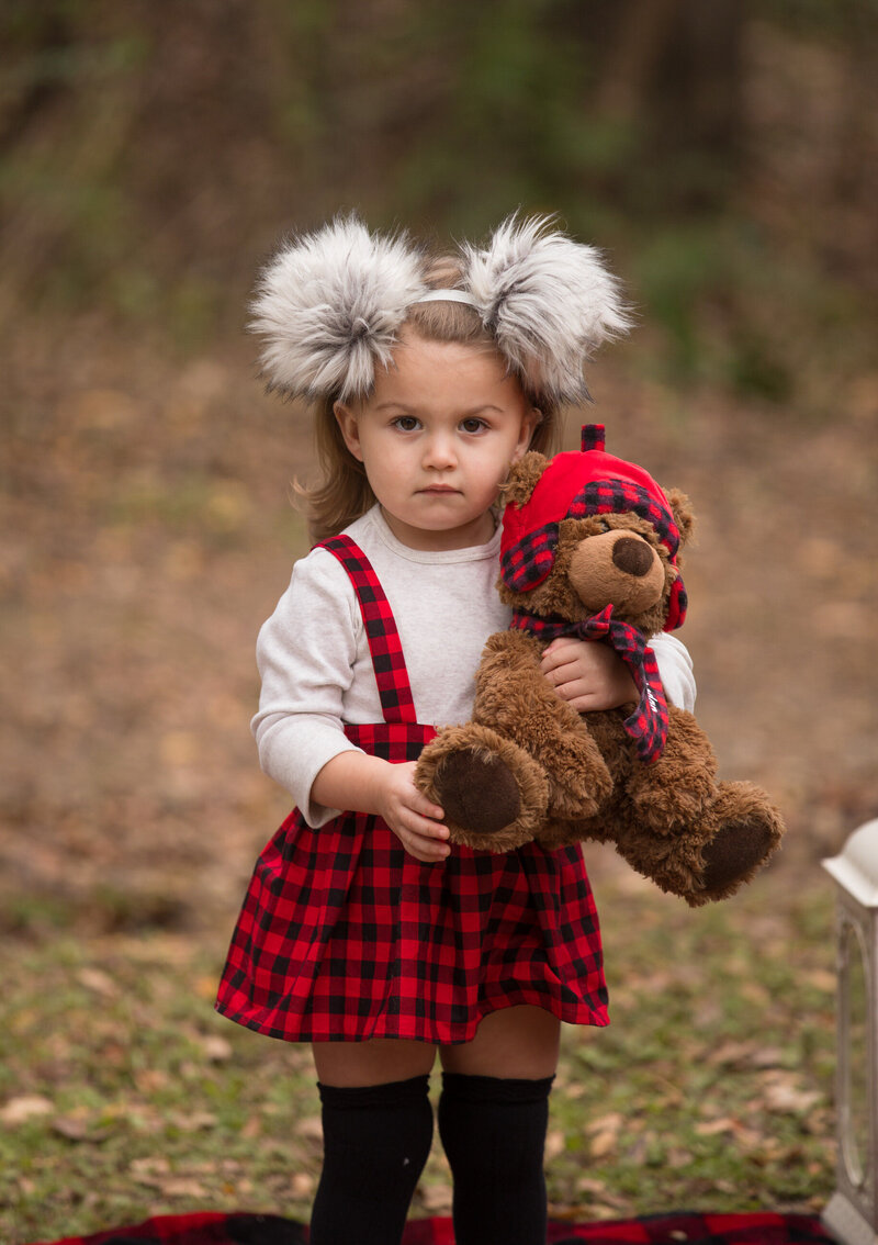 girl-holding-teddy-bear-in-matching-buffalo-check-pattern-in-arlington-tx