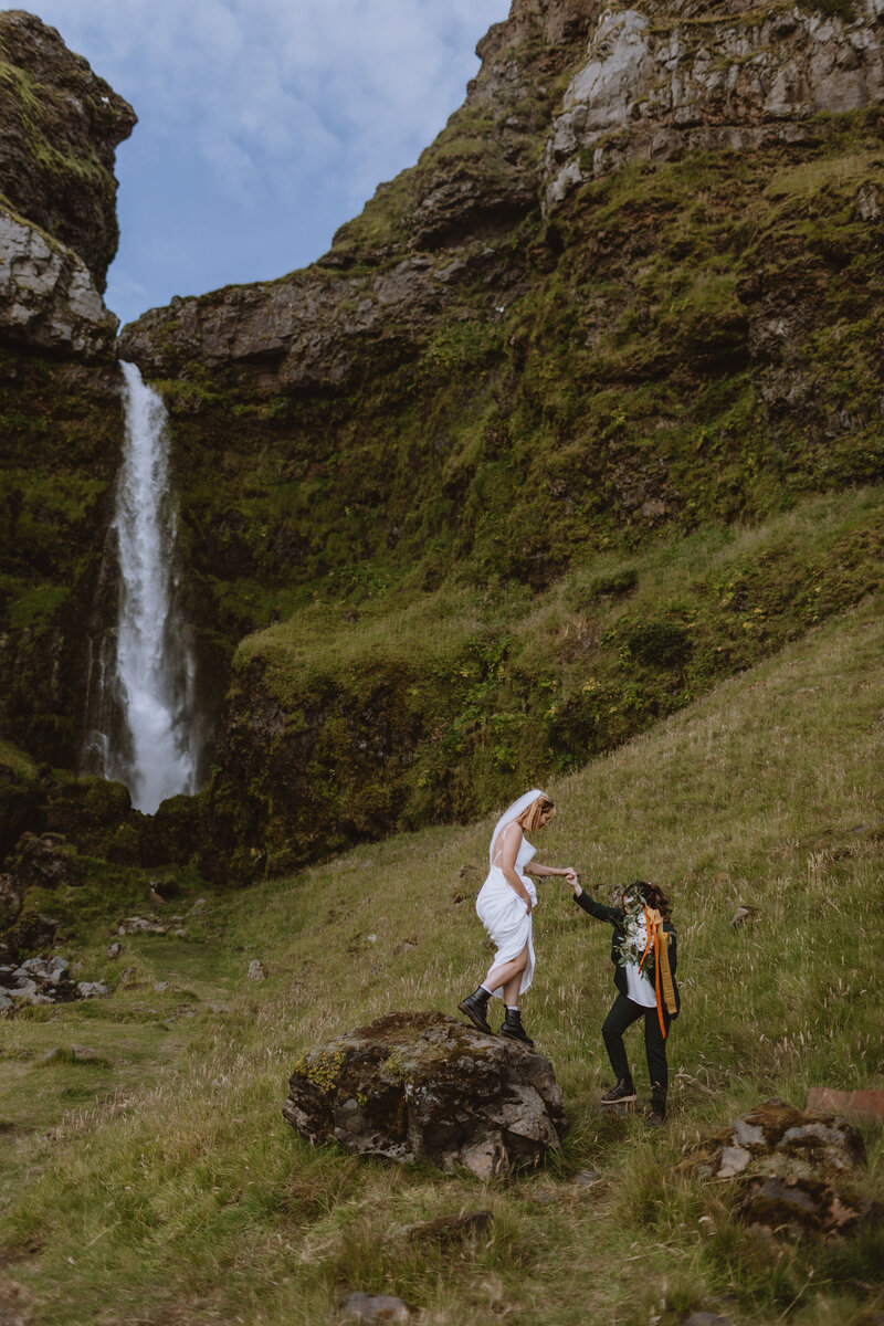 Brides in front of waterfall