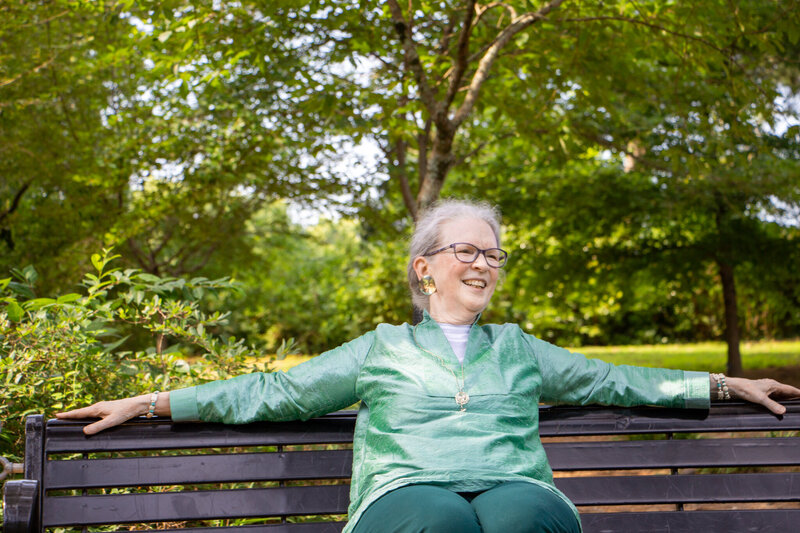 Female Author and memoirs mentor sitting on park bench