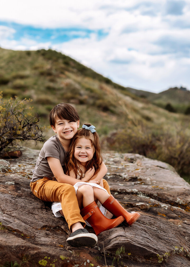 cute siblings playing during the session in loveland, co.